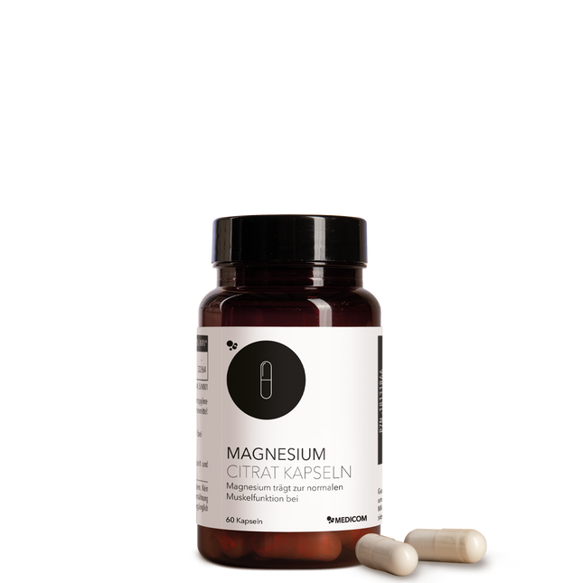 Die Produktdose von Magnesium Citrat Kapseln von Medicom mit zwei Kapseln im Vordergrund