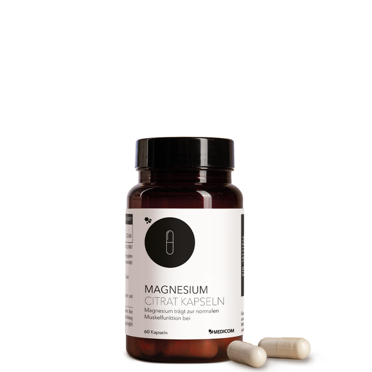 Die Produktdose von Magnesium Citrat Kapseln von Medicom mit zwei Kapseln im Vordergrund